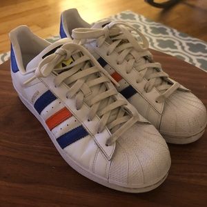 Men’s Adidas Superstars with navy/orange stripes